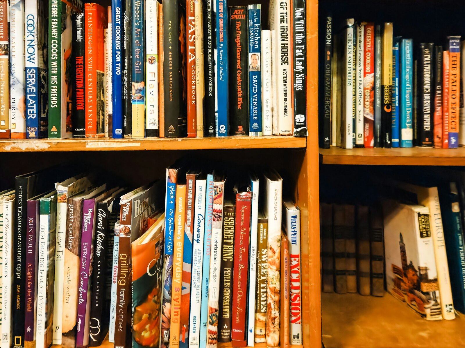 Wooden shelves packed floor to ceiling with books