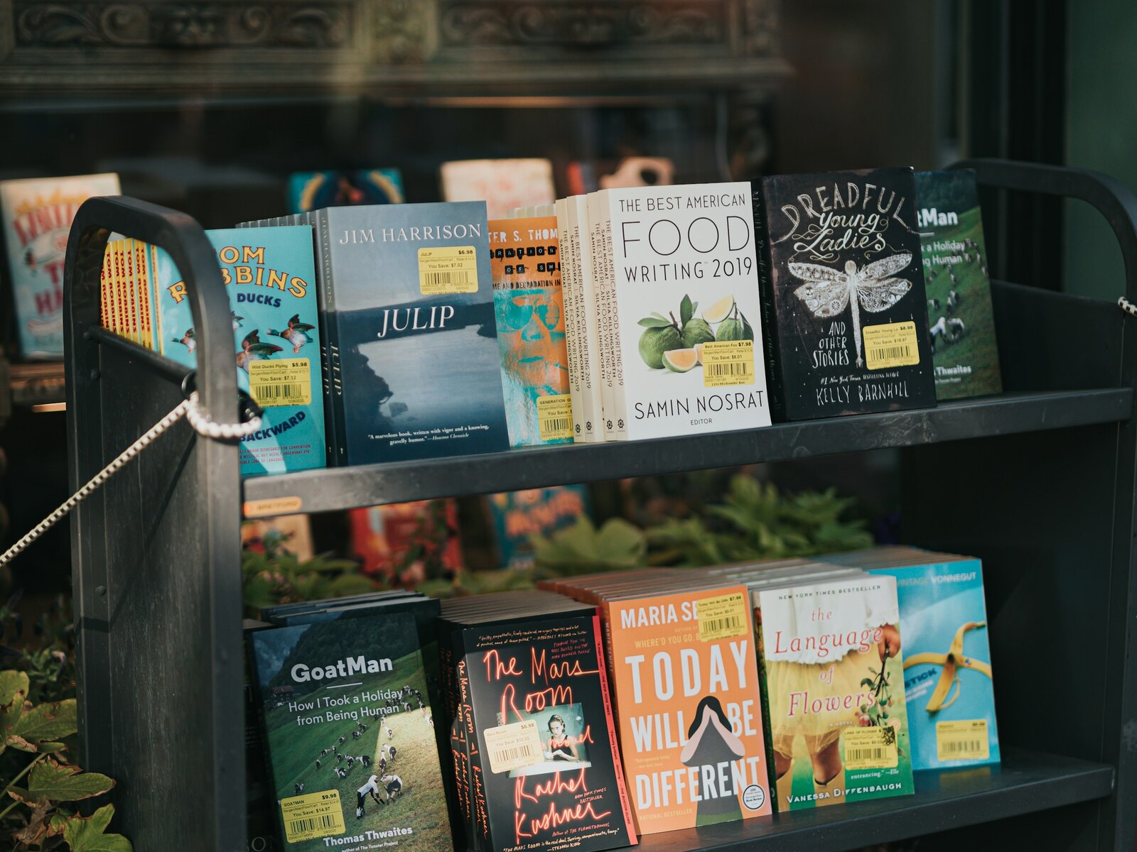 A bright table of new book releases near the shop window